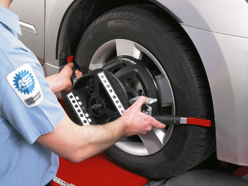 technician putting quickgrip adaptor on vehicle tire
